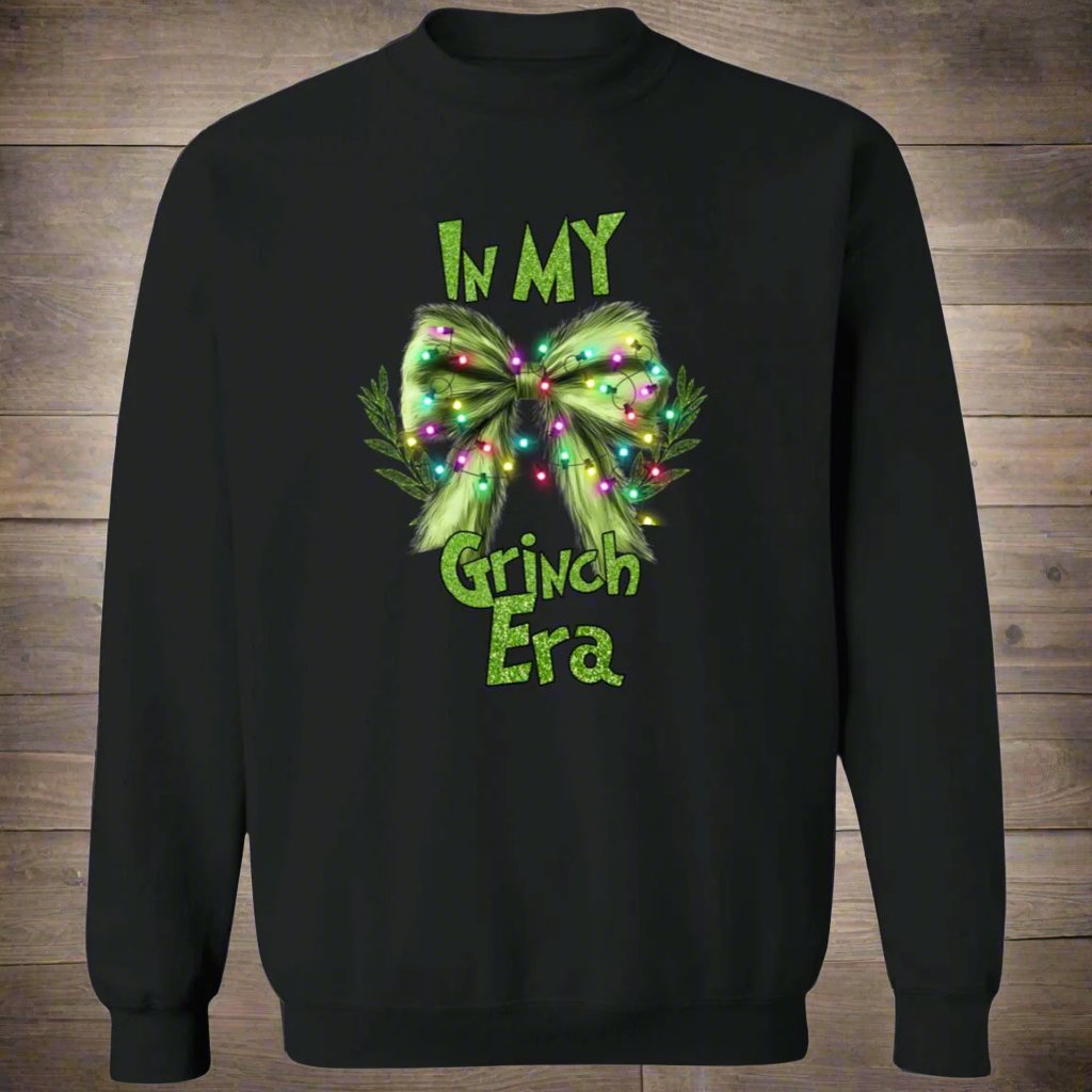 Green holiday sweater featuring the playful text 'In My Grinch Era,' designed for a cozy and humorous festive look